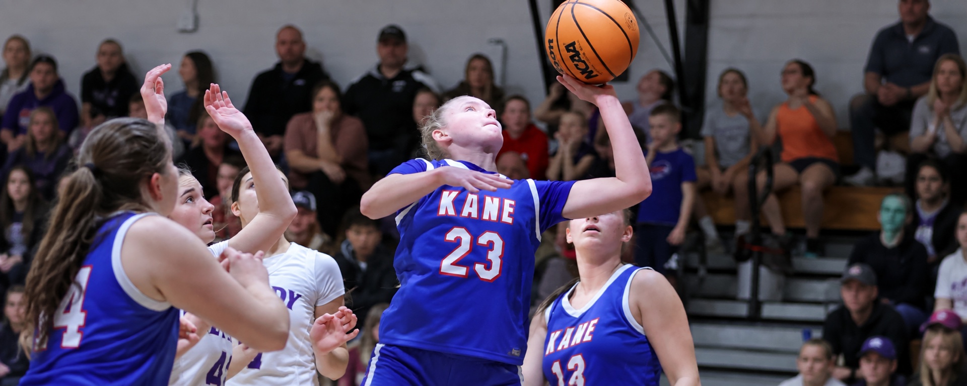 Kane basketball player number 23 driving to the basket during a game.